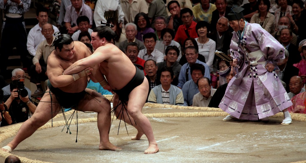Sumo bout initial charge wrestlers jump Tokyo Japan