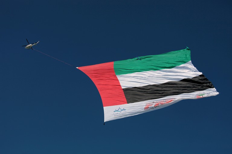 UAE flag under helicopter tourism visit hotel work Emirates