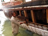 Carpenter fix a dhow Dibba seaport Oman