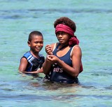 Boy and girl fishing in a Fijian Lagoon